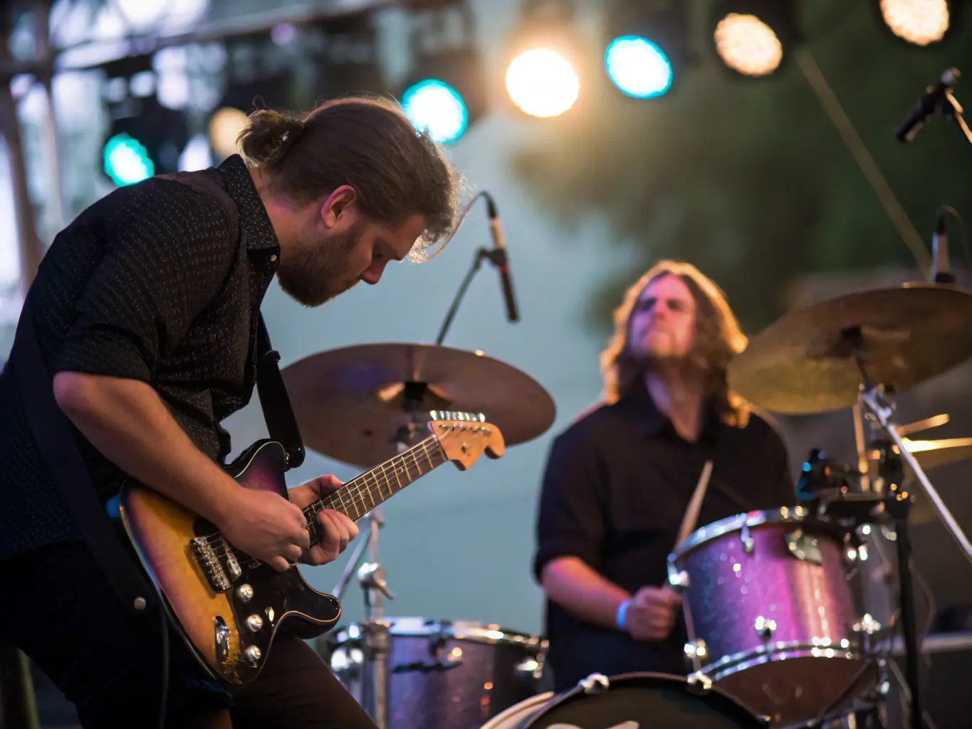 A dynamic concert scene with musicians performing at an ELIXION-sponsored event, emphasizing the organization's commitment to supporting musical arts.